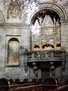 Vertical metallic pipe organ mounted on the wall